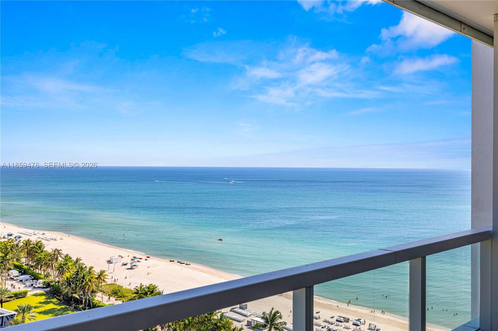 A high-angle view from a balcony overlooks a sandy beach and the ocean — 4391 Collins Ave, Miami Beach FL 33140, MIAMI BEACH, FL