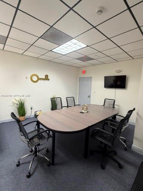 A conference room features a wooden oval table, six office chairs, and a wall-mounted television — 12150 SW 128th Ct Suite 218, Miami FL 33186, MIAMI, FL