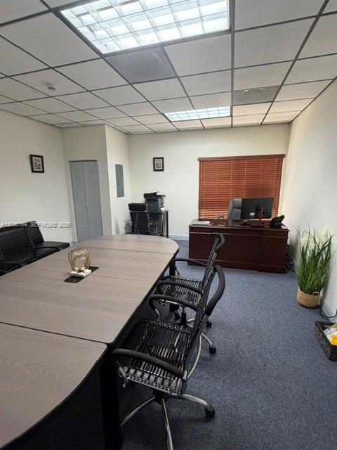 An office space features a conference table, chairs, a desk, and a window with blinds — 12150 SW 128th Ct Suite 218, Miami FL 33186, MIAMI, FL