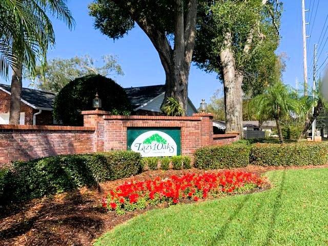 A brick entrance sign for Lazy Oaks sits in front of a house and trees — 5171 LAZY OAKS DRIVE, WINTER PARK, FL