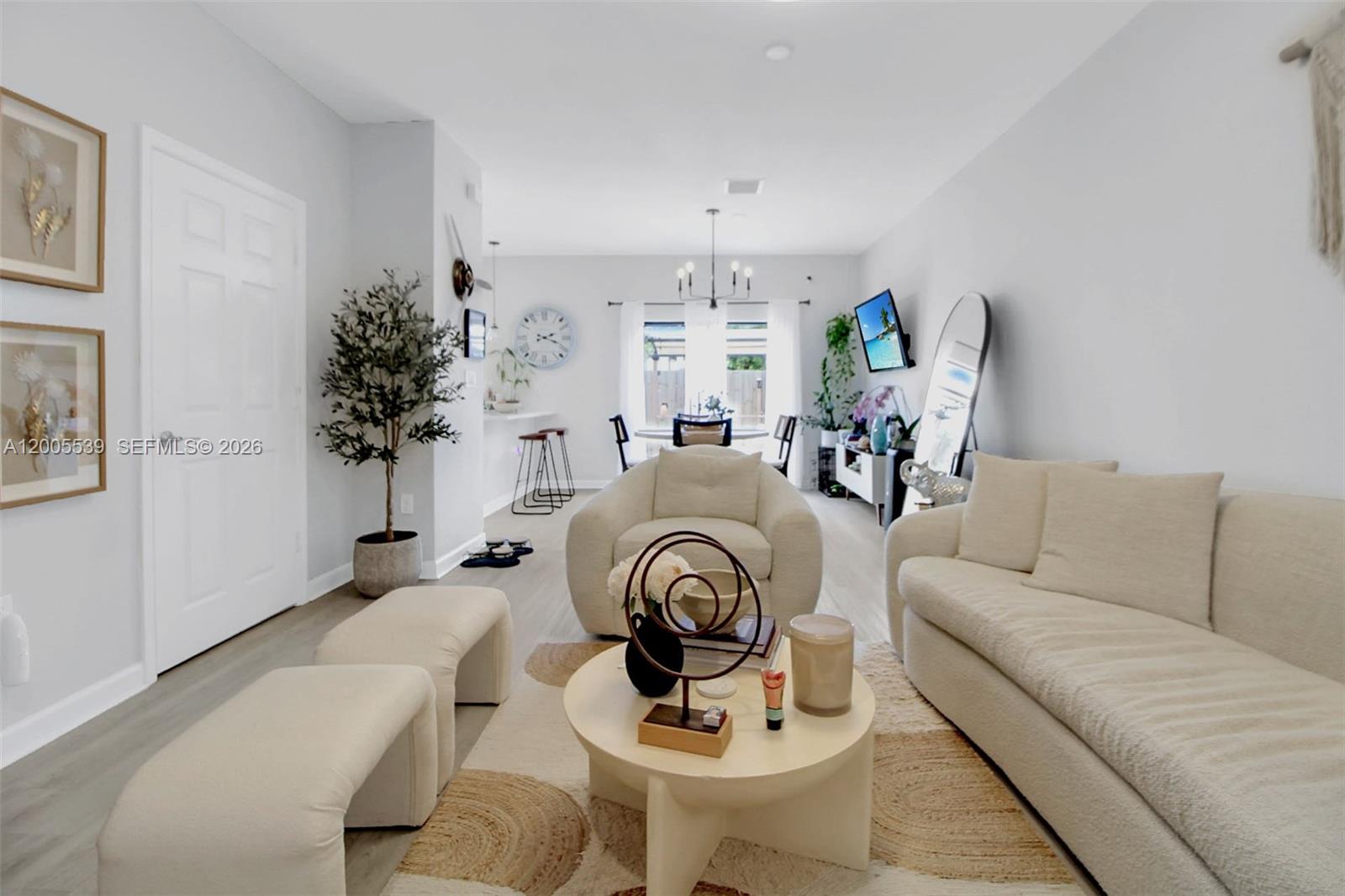 A living room features a cream sofa, a round coffee table, and a dining area — 12766 SW 229th Ter, Miami FL 33170, MIAMI, FL