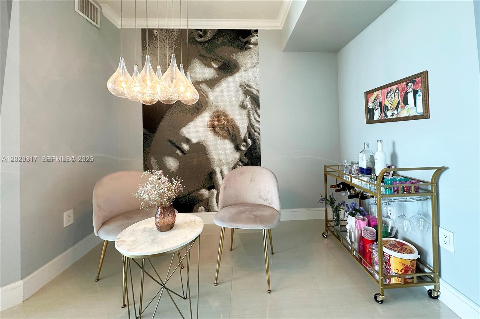 A dining area features two velvet chairs, a marble table, and a large mosaic wall mural — 2000 N Bayshore Dr # 614, Miami FL 33137, MIAMI, FL