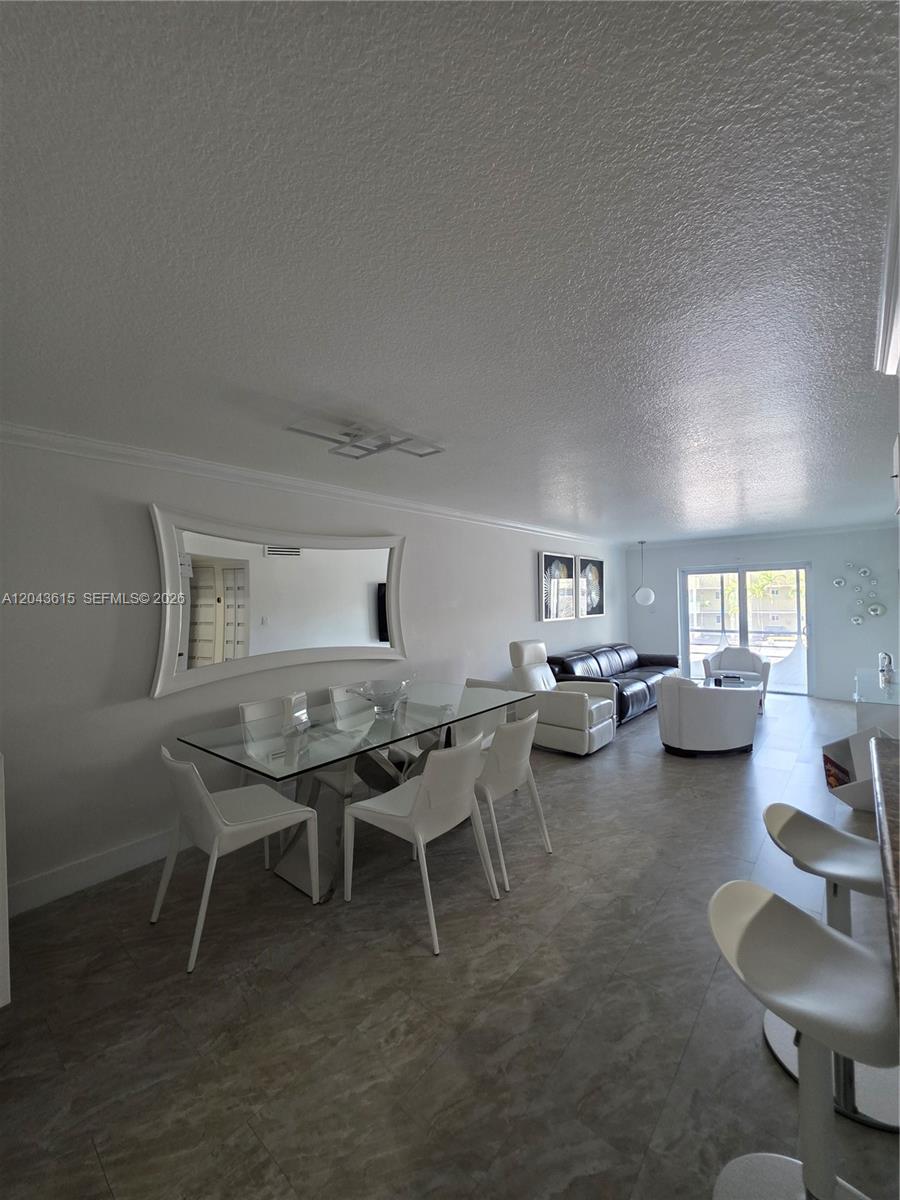 A dining area and living room feature white furniture, tile floors, and a glass table — 4670 W 13th Ln # 206, Hialeah FL 33012, HIALEAH, FL