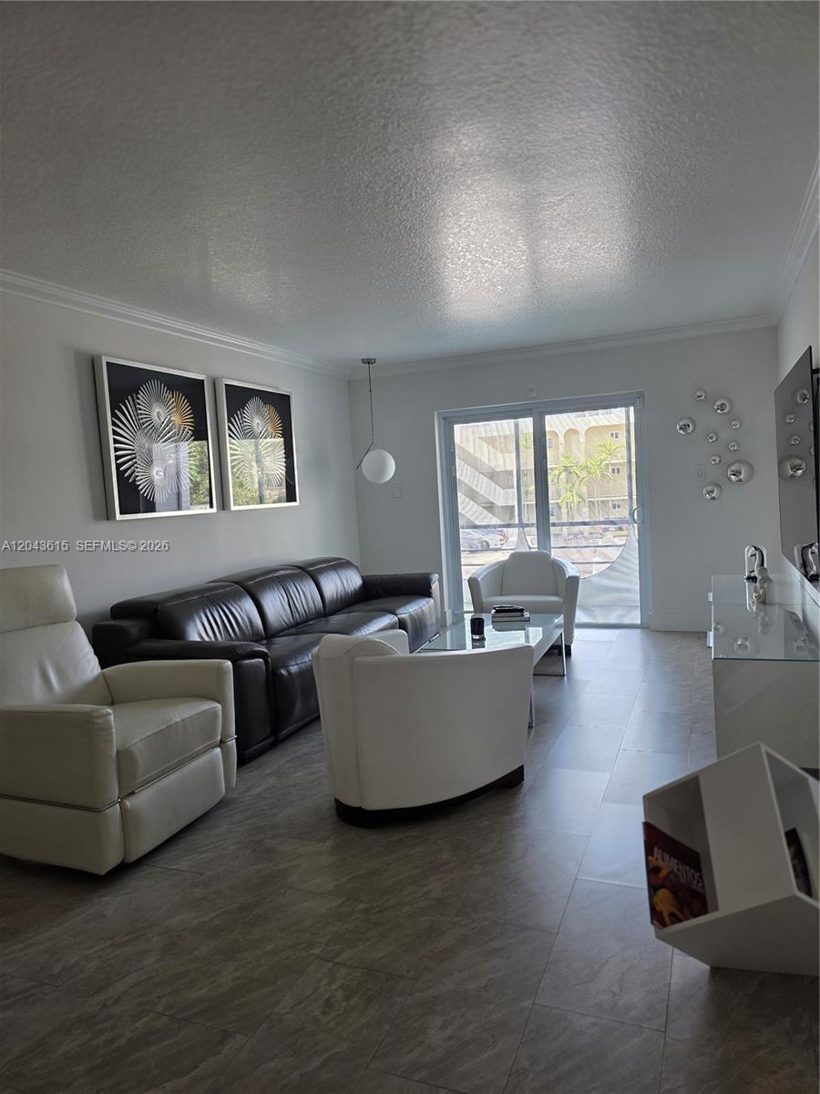 A living room features a dark leather sofa, white armchairs, and tile flooring — 4670 W 13th Ln # 206, Hialeah FL 33012, HIALEAH, FL
