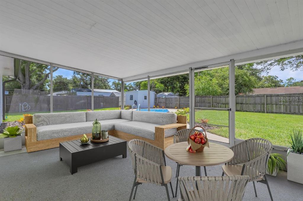 A screened-in patio features a sectional sofa, a dining set, and a view of a backyard — 3400 SHEPHERD ROAD, MULBERRY, FL