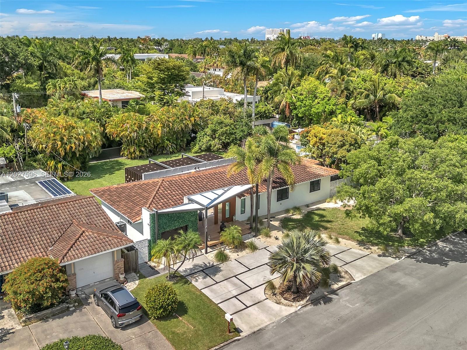 An aerial view shows a single-story house with a tiled roof and a paved driveway — 1141 Adams St, Hollywood FL 33019, HOLLYWOOD, FL