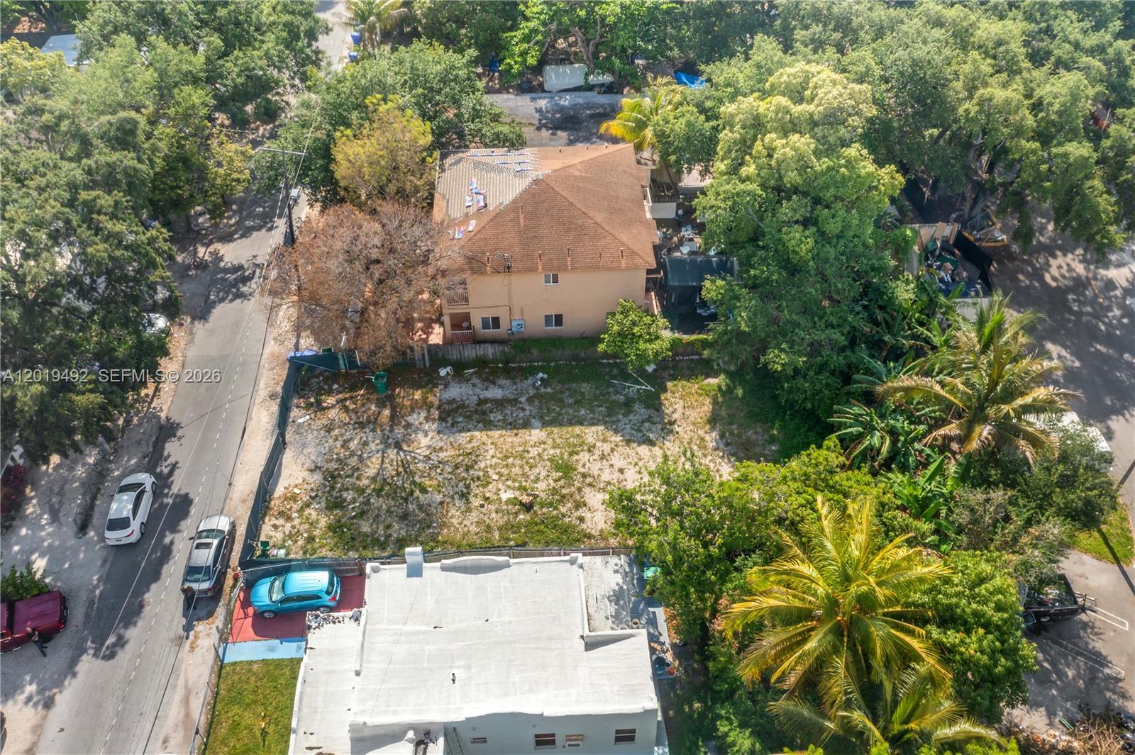 An aerial view shows a vacant lot situated between two multi-story residential buildings — 161 NE 60th St, Miami FL 33137, MIAMI, FL