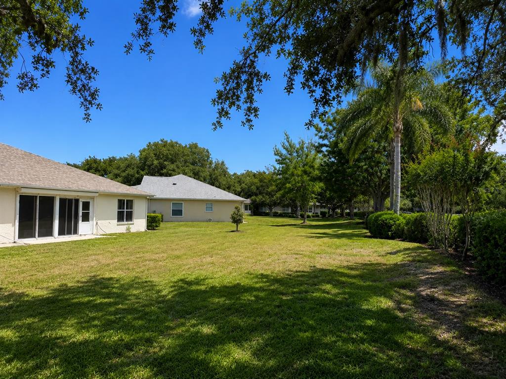 A white screen door leads to a dark front door with a transom window above — 822 MCCALLISTER AVENUE UNIT 822, SUN CITY CENTER, FL