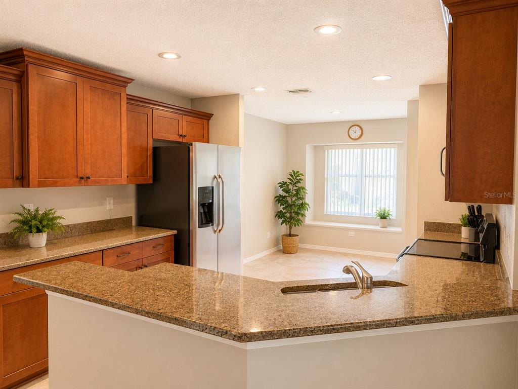 A living room features a beige sofa, patterned armchair, coffee table, and sliding glass doors — 822 MCCALLISTER AVENUE UNIT 822, SUN CITY CENTER, FL