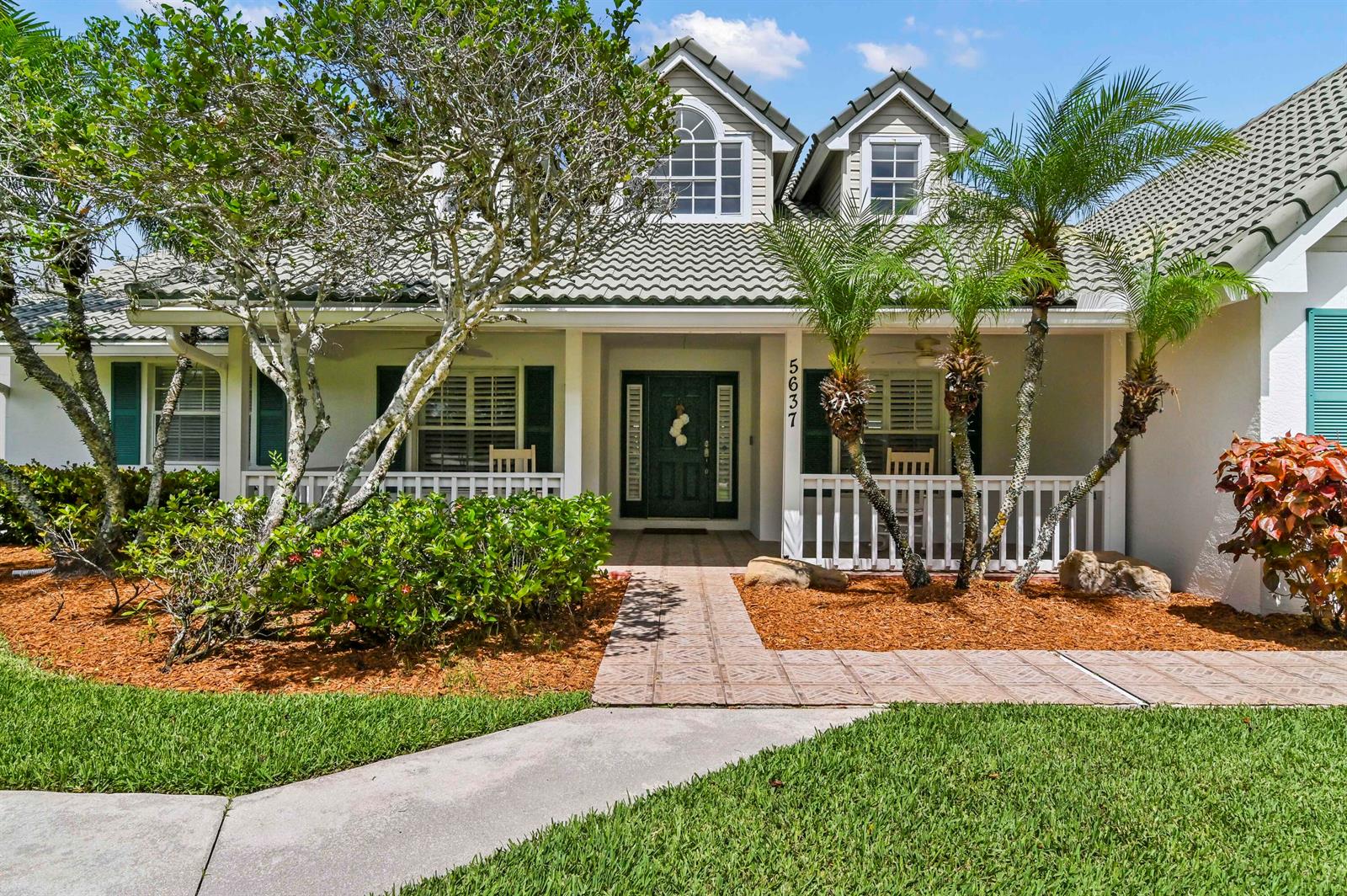 A single-story house with a covered porch, dormer windows, and a tiled roof — 5637 Lago Del Sol Drive, Lake Worth FL 33449, LAKE WORTH, FL