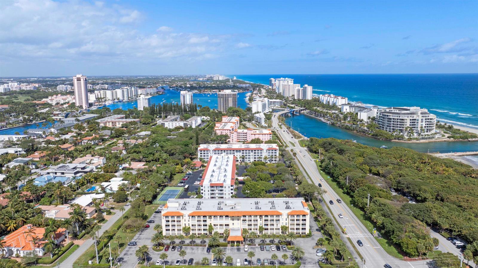 An aerial view shows a multi-story residential complex near a coastal waterway and beach — 951 De Soto Road # 232, Boca Raton FL 33432, BOCA RATON, FL