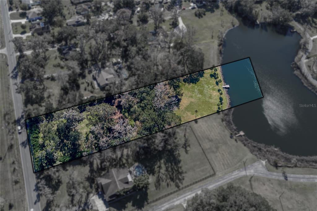 An aerial view shows a rectangular property lot featuring a house, trees, and a dock — 11045 FORT KING ROAD, DADE CITY, FL