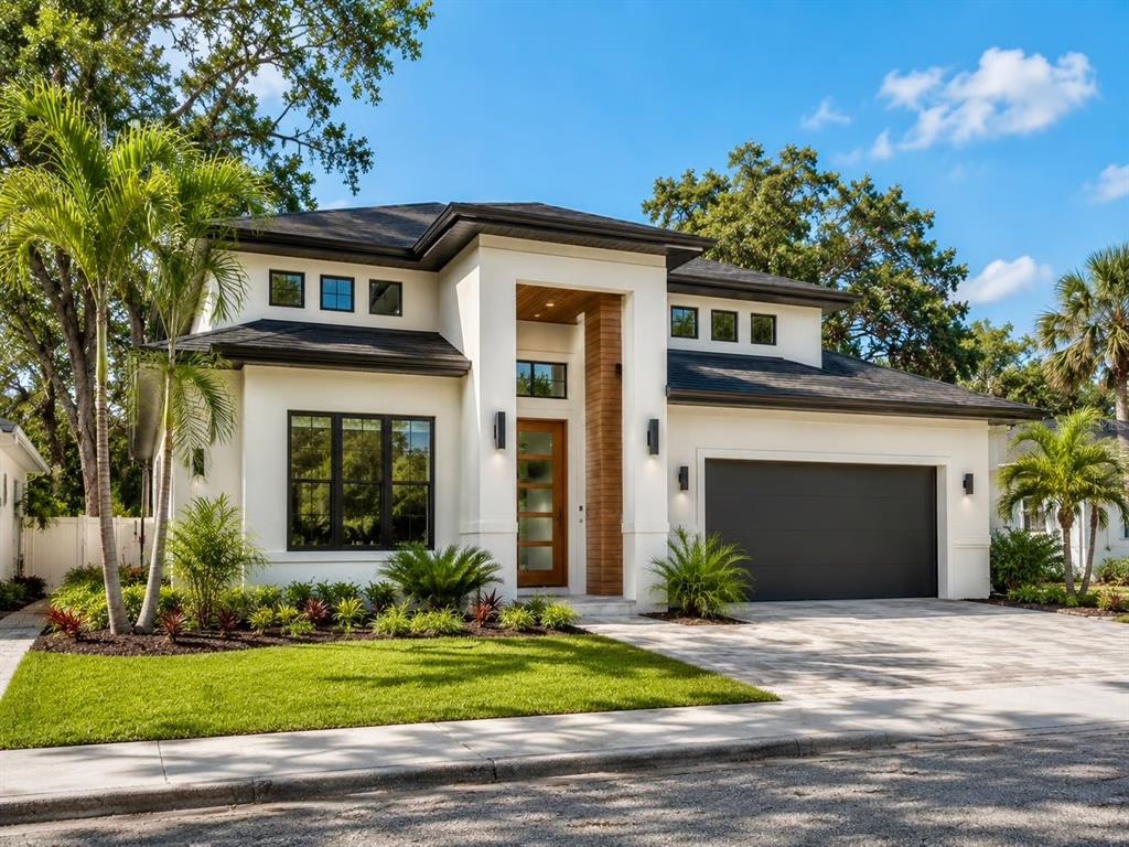 A modern two-story house with a white exterior, dark roof, and a wood-accented entryway — 0 BLOSSOM AVENUE, TAMPA, FL