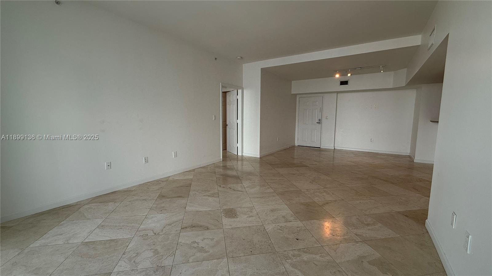 An empty room features white walls, a tiled floor, and a doorway leading elsewhere — 1155 Brickell Bay Dr, Miami FL 33131, MIAMI, FL