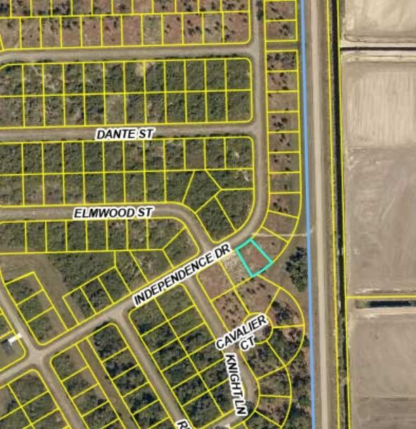 This is a satellite map showing a highlighted residential lot at a street intersection — 523 Independence Drive, FL 33935, FL