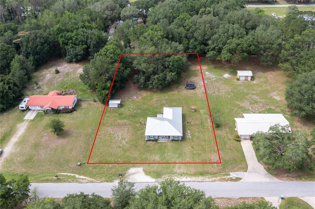 An aerial view shows a house with a red-outlined property boundary on a grassy lot — 2830 NW 174 STREET, TRENTON, FL