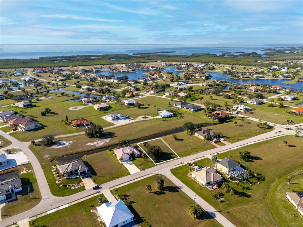 An aerial view shows a vacant residential lot outlined in white within a suburban neighborhood — 17277 CAPE HORN BOULEVARD, PUNTA GORDA, FL