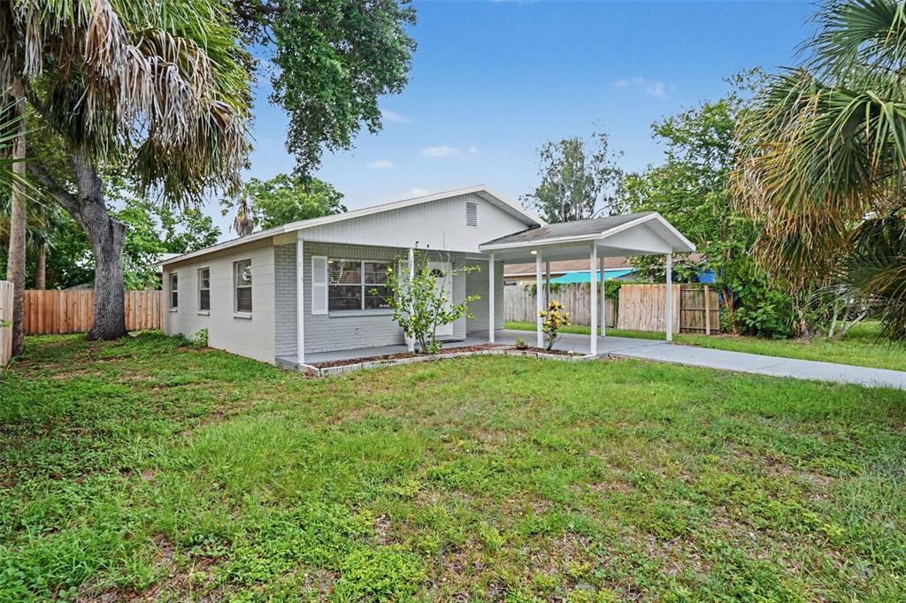A living room features a sectional sofa, a coffee table, and tile flooring — 5733 66TH LANE N, ST PETERSBURG, FL