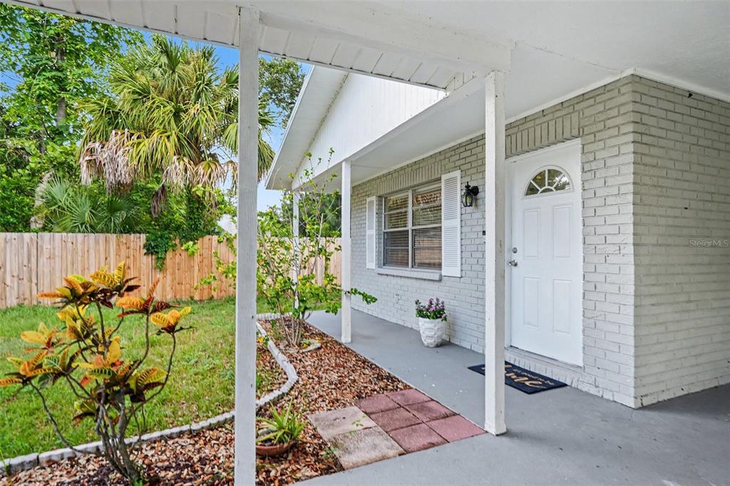 A bedroom features a bed with neutral bedding, two nightstands, a dresser, and a ceiling fan — 5733 66TH LANE N, ST PETERSBURG, FL