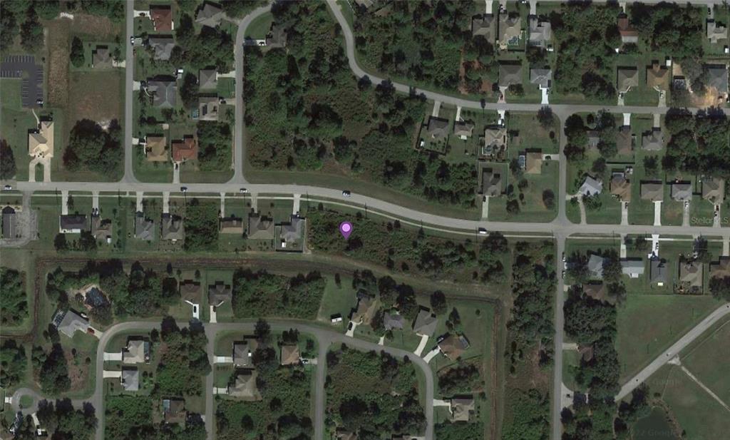 This aerial view shows a vacant residential lot marked with a purple pin — W PRICE BOULEVARD, NORTH PORT, FL