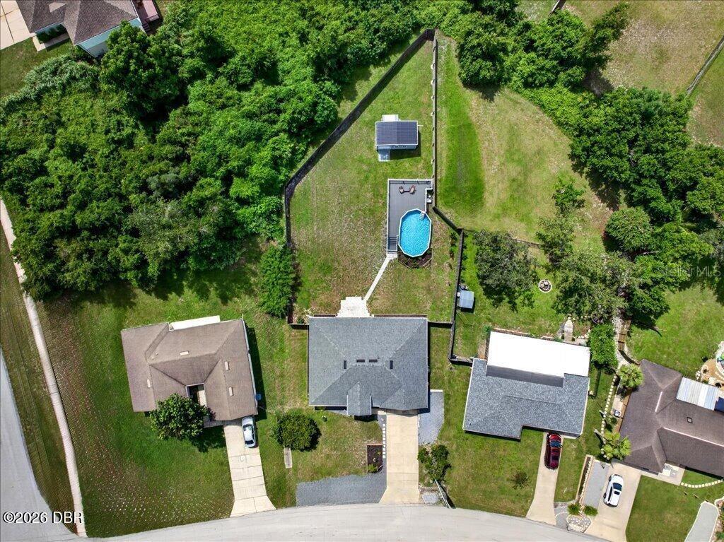 An aerial view shows a residential property with a house, a pool, and a shed — 1901 EDEN DRIVE, DELTONA, FL