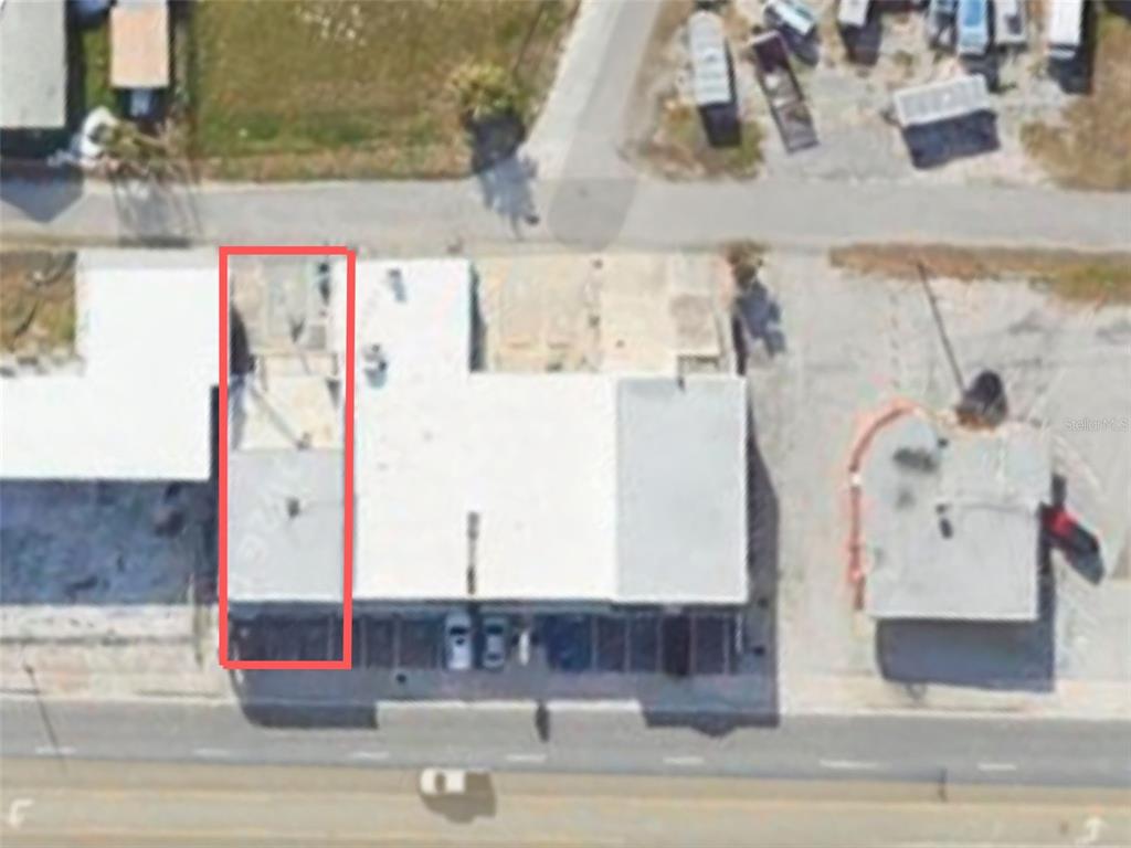 This aerial view shows a commercial building with a red rectangle highlighting a specific section — 2016 S ATLANTIC AVENUE, DAYTONA BEACH, FL