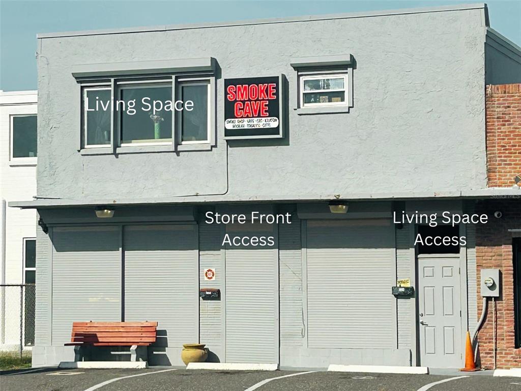 A two-story gray building with a storefront, a separate entrance, and an upper-level window — 2016 S ATLANTIC AVENUE, DAYTONA BEACH, FL