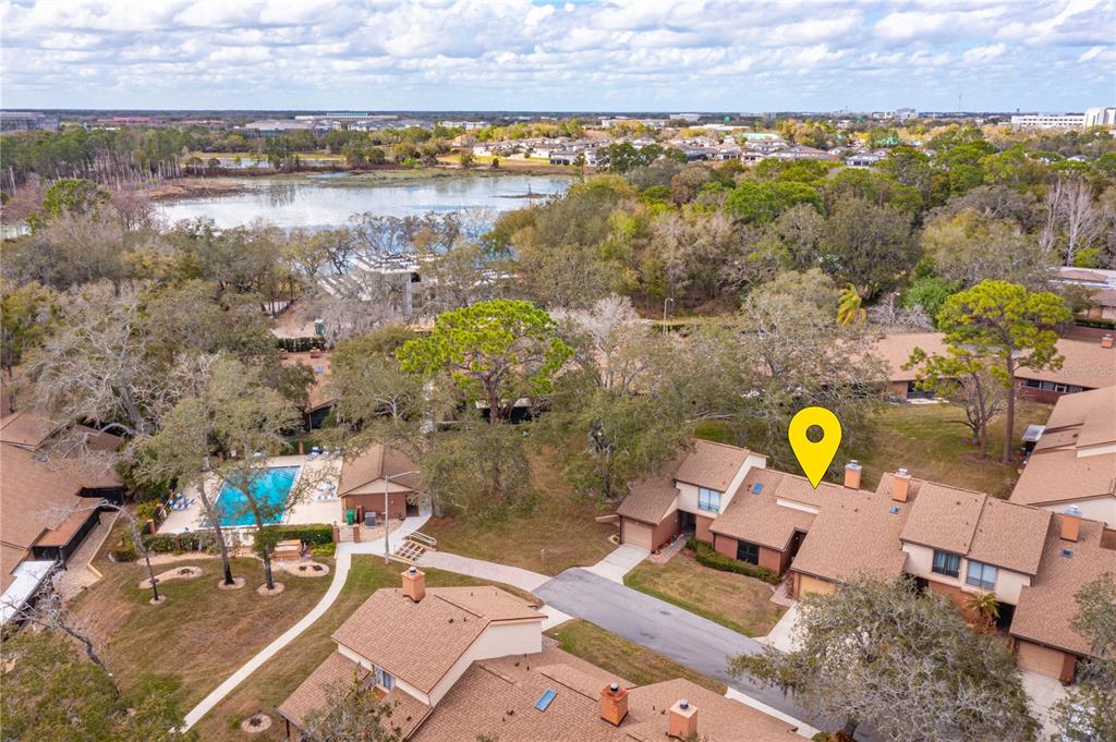 A kitchen features dark wood cabinets, stainless steel appliances, and light-colored granite countertops — 106 CARLI COURT UNIT 106, LAKE MARY, FL