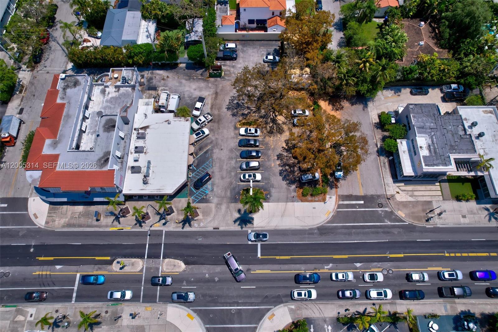 An aerial view shows a commercial building with a parking lot and adjacent street traffic — 7201 Biscayne Blvd, Miami FL 33138, MIAMI, FL