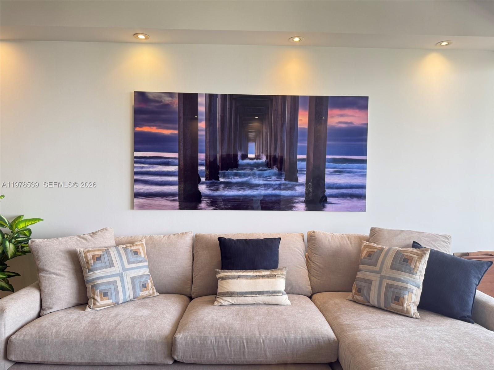 A beige sectional sofa sits beneath a large landscape print of a pier — 251 Crandon Blvd # 606, Key Biscayne FL 33149, KEY BISCAYNE, FL