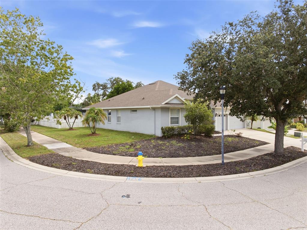A single-story house with a light-colored exterior sits on a corner lot with landscaping — 508 DEBRA DRIVE, BRANDON, FL