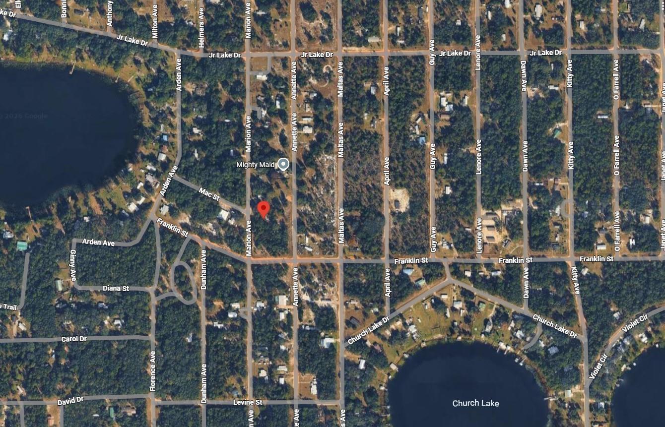 This is a satellite map view of a residential neighborhood with streets and a lake — Tbd Marion Avenue, FL 32148, FL