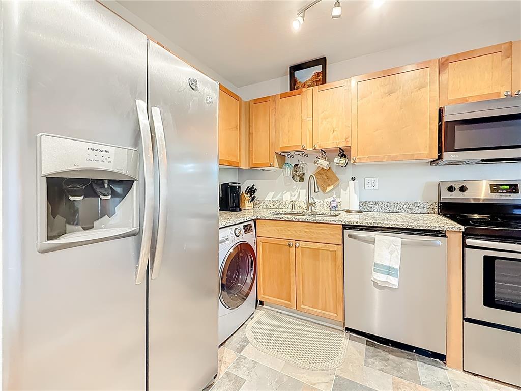 A kitchen features stainless steel appliances, light wood cabinets, and granite countertops — 3893 POMPANO DRIVE SE UNIT C, ST PETERSBURG, FL