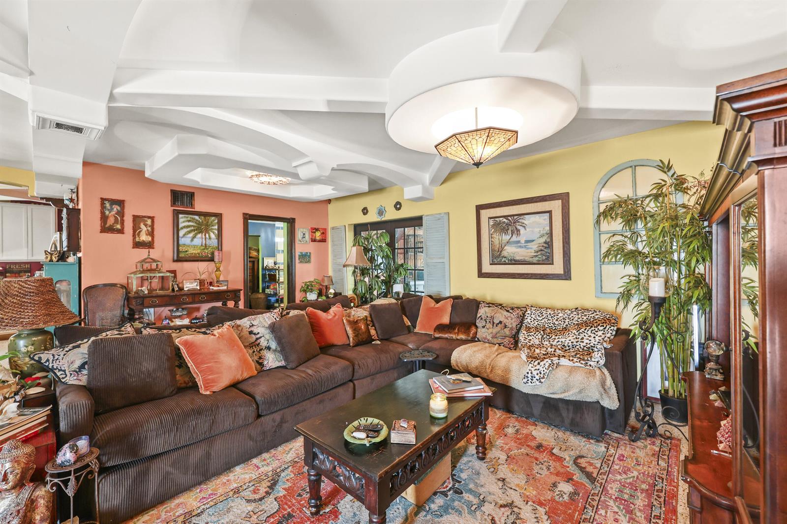 A living room features a large brown sectional sofa, a coffee table, and vaulted ceilings — 112 San Juan Drive, Palm Springs FL 33461, PALM SPRINGS, FL