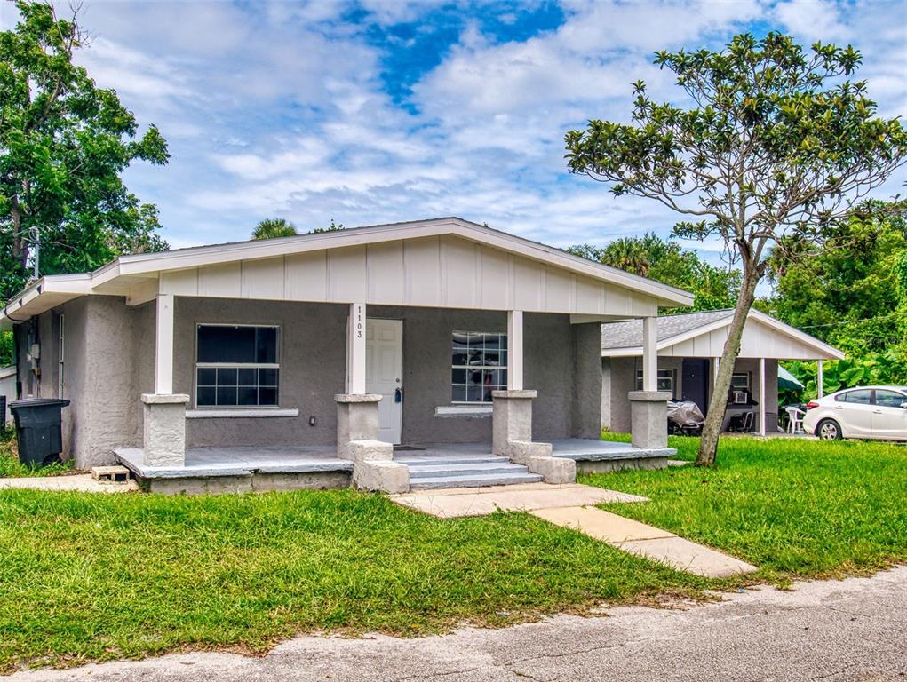A gray, single-story house with a covered front porch and a detached carport — 1103 WASHINGTON STREET, NEW SMYRNA BEACH, FL