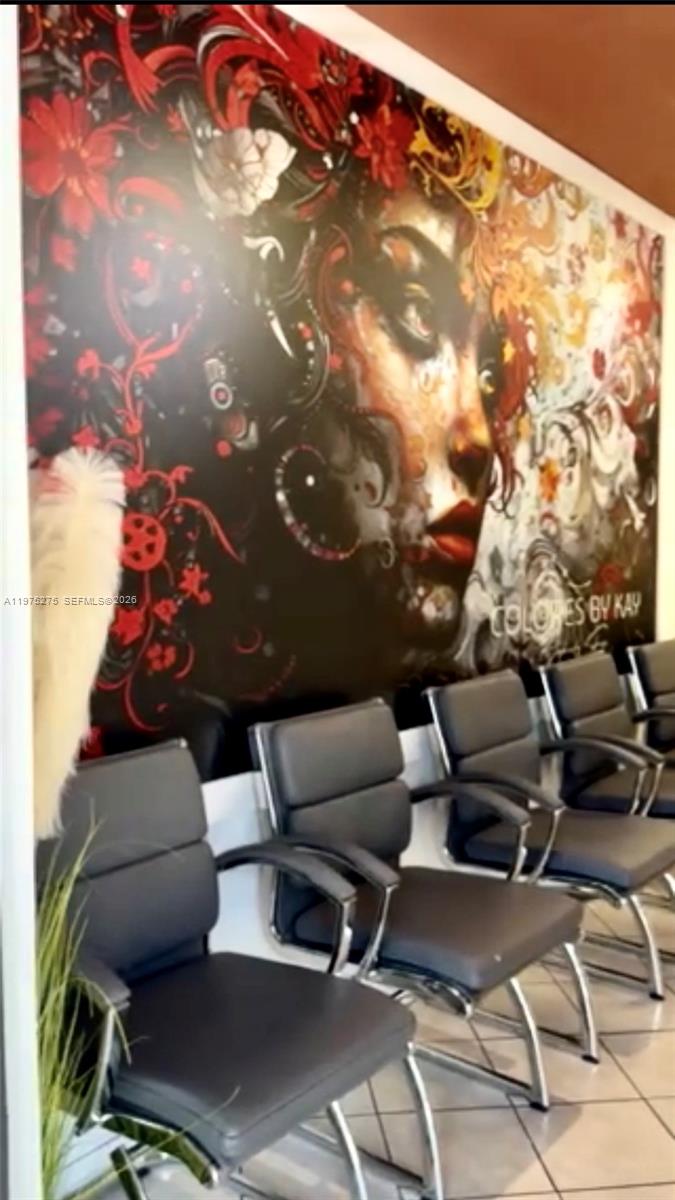A row of black chairs sits in front of a wall featuring a large mural — 7764 NW 44, Sunrise FL 33351, SUNRISE, FL