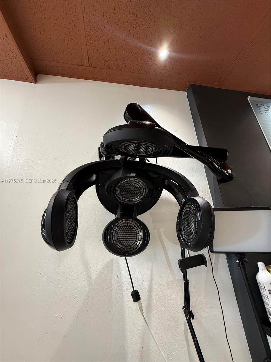 A wall-mounted hair dryer with multiple circular heating elements is attached to a white wall — 7764 NW 44, Sunrise FL 33351, SUNRISE, FL