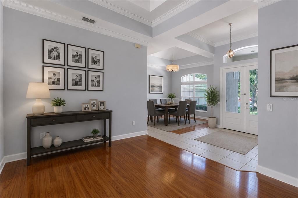 A foyer with hardwood floors leads to a dining room with a tray ceiling — 1337 BALLENTYNE PLACE, APOPKA, FL