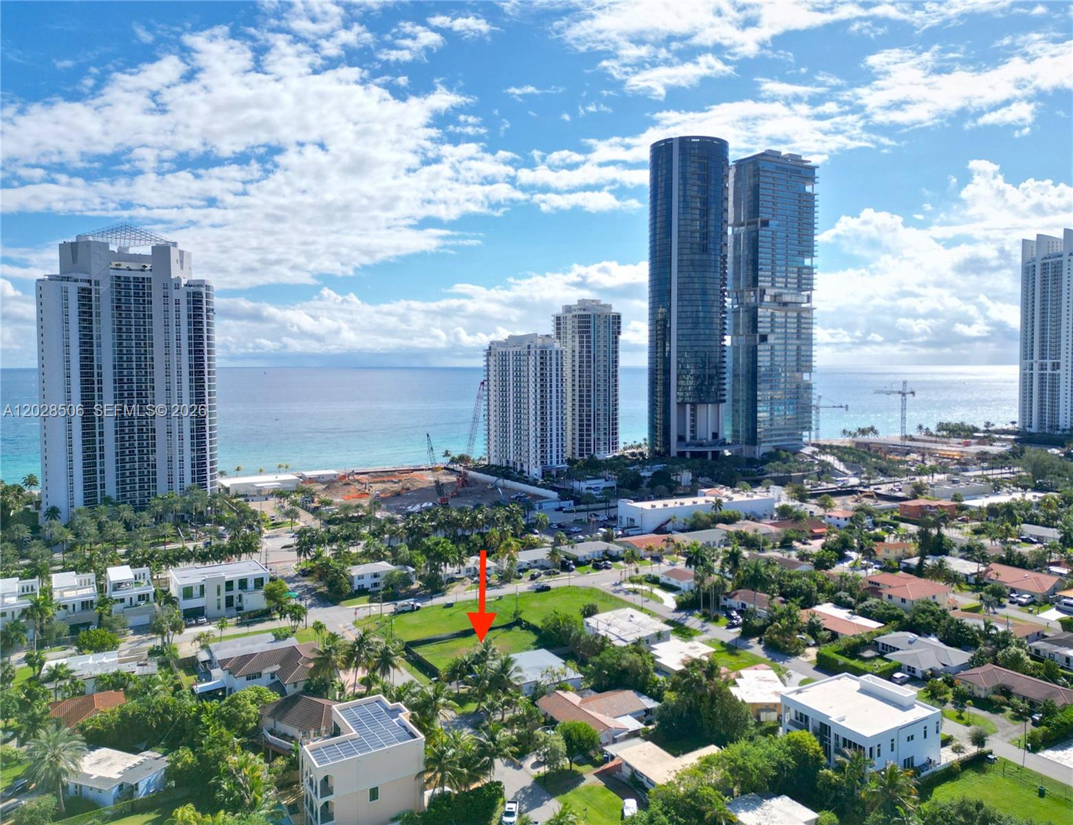 An aerial view shows a residential lot marked by a red arrow near high-rise buildings — 212 189th St, Sunny Isles Beach FL 33160, SUNNY ISLES BEACH, FL