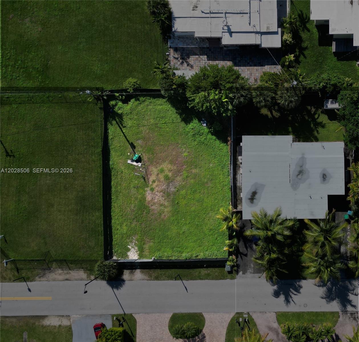 An aerial view shows a vacant, rectangular residential lot situated between two existing houses — 212 189th St, Sunny Isles Beach FL 33160, SUNNY ISLES BEACH, FL