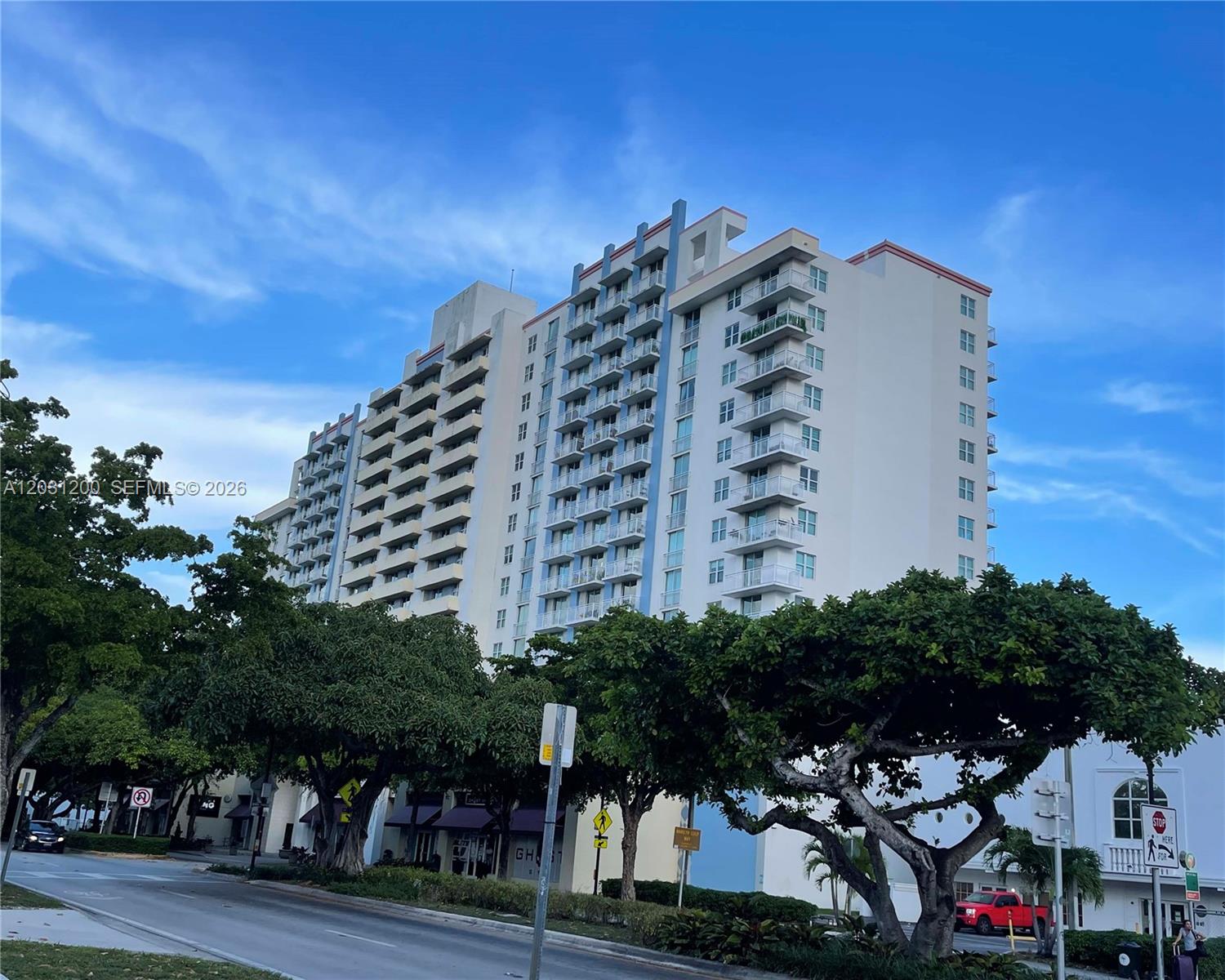 The exterior of a multi-story residential building features a stone-clad entrance with a prominent sign — 3000 Coral Way # 1501, Miami FL 33145, MIAMI, FL