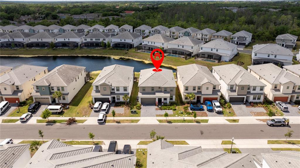 An aerial view shows a row of suburban houses with a red location pin marker — 2512 SHANTI DRIVE, KISSIMMEE, FL