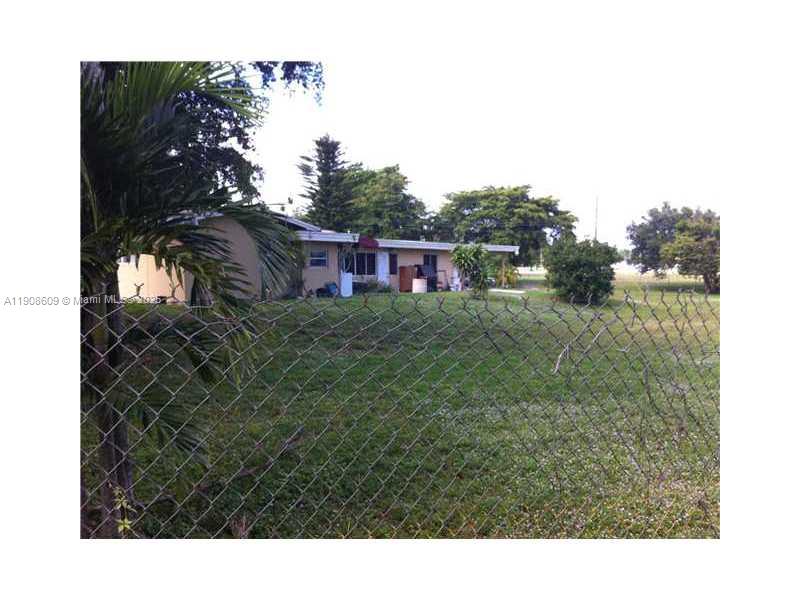 A single-story house with a chain-link fence in the foreground and a grassy yard — 5920 SW 45TH WY, Davie FL 33314, DAVIE, FL