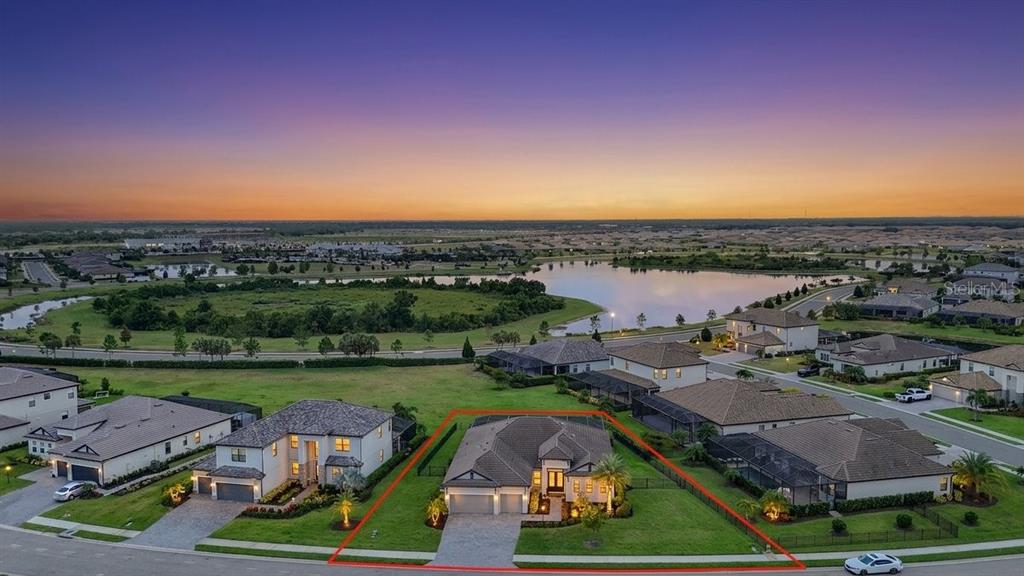 An aerial view of a suburban house with a red outline in a residential neighborhood — 16228 TRADEWIND TERRACE, LAKEWOOD RANCH, FL