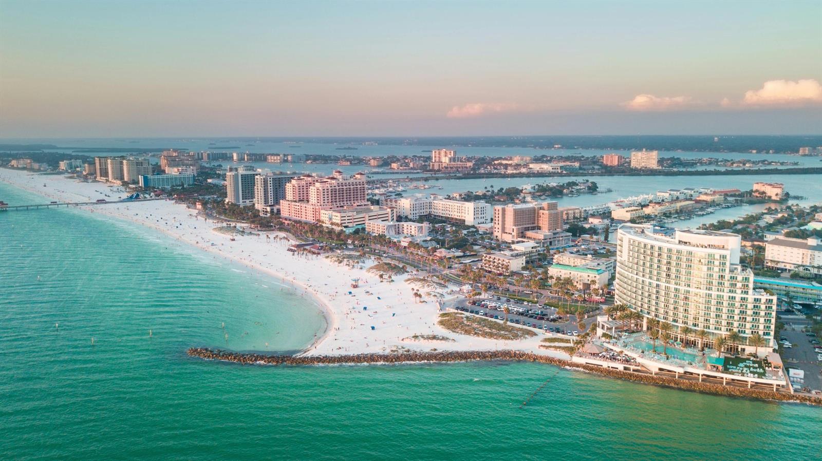 An aerial view shows a white sand beach lined with hotels and resorts along the ocean — 2348 Shelley Street # 1, Clearwater FL 33765, CLEARWATER, FL