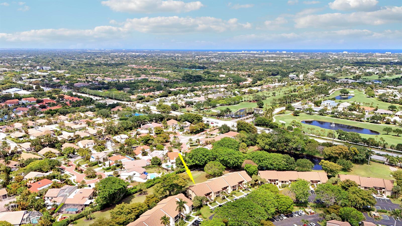 An aerial view shows a residential neighborhood with a yellow arrow pointing to a townhouse — 5121 Oak Hill Lane # 412, Delray Beach FL 33484, DELRAY BEACH, FL
