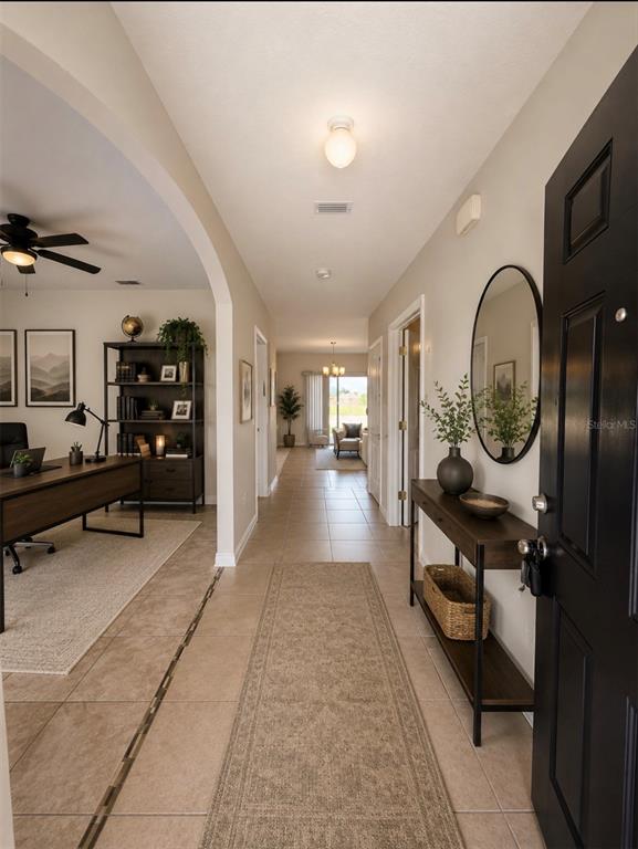 An entryway leads to a home office and a hallway with tile flooring — 885 FREEDOM BOULEVARD, DAVENPORT, FL