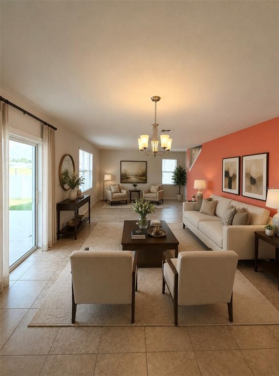 A living room features a coral accent wall, neutral furniture, tile flooring, and a chandelier — 885 FREEDOM BOULEVARD, DAVENPORT, FL