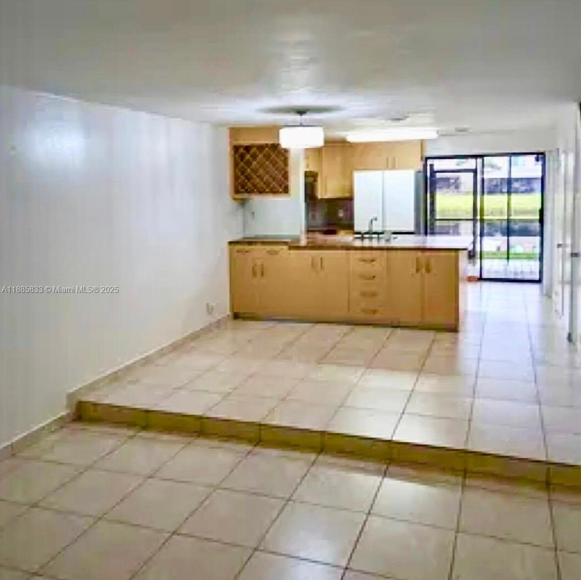 This interior view shows a kitchen with light wood cabinets and tile flooring — 5164 S University Dr, Davie FL 33328, DAVIE, FL