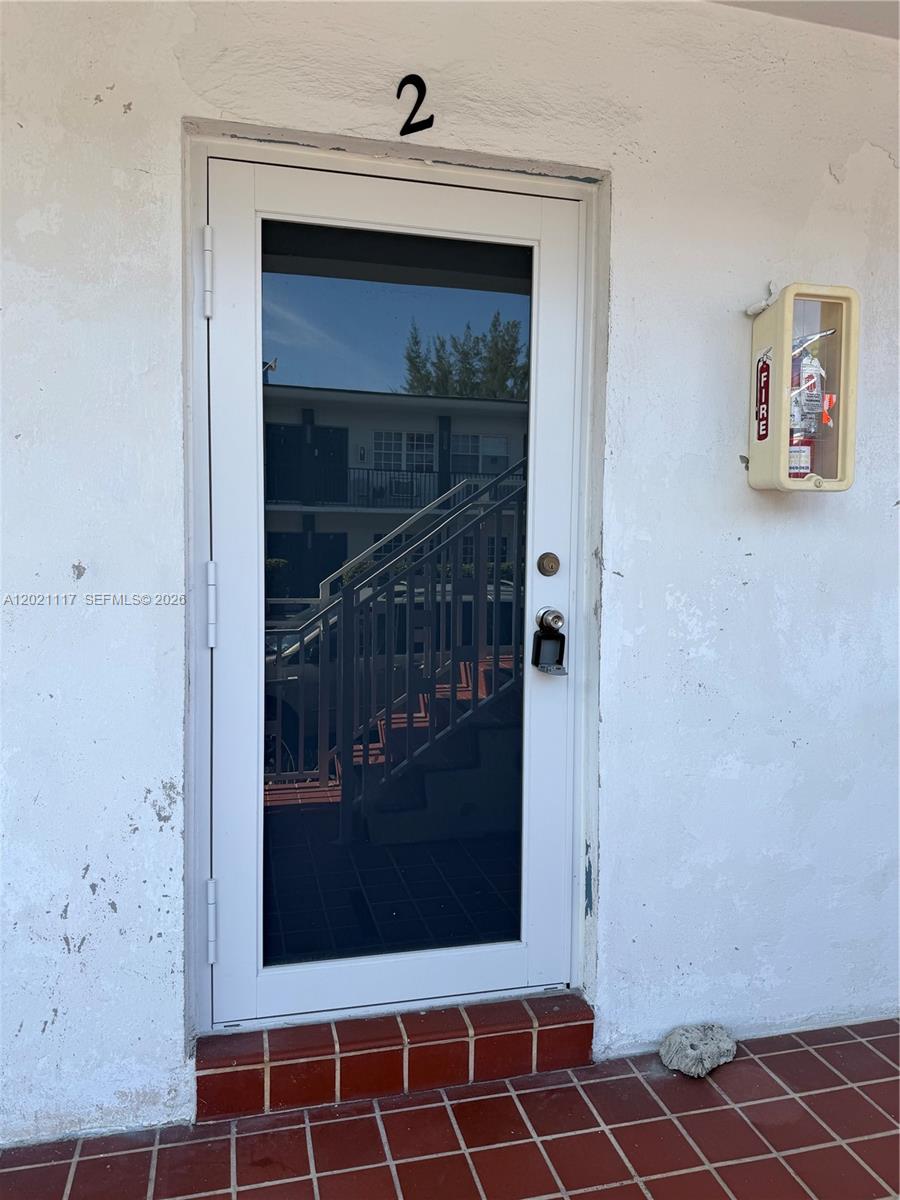 A white door labeled with the number two features a glass panel and lockbox — 500 77th St # 2, Miami Beach FL 33141, MIAMI BEACH, FL